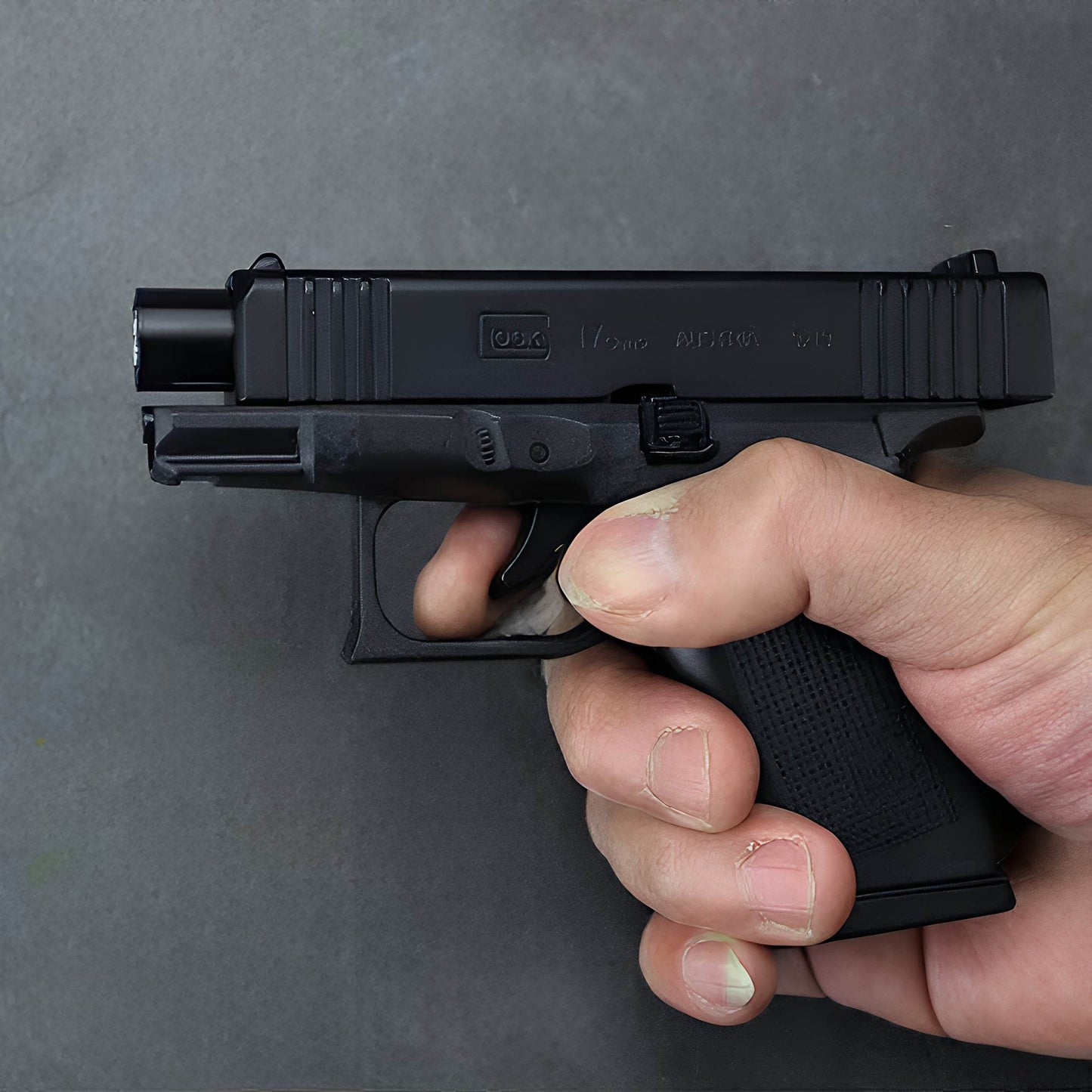 Hand holding Glock 17 Pistol Lighter demonstrating movable slide action